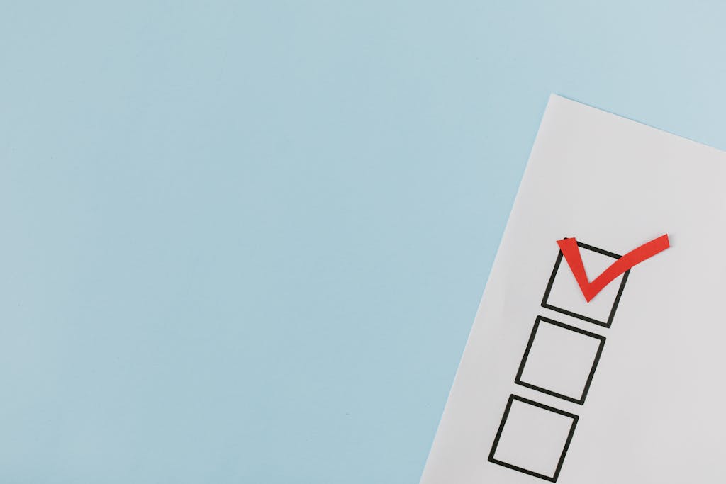 A checklist with a red checkmark symbolizing eligibility for Canada Child Benefit (CCB) program.